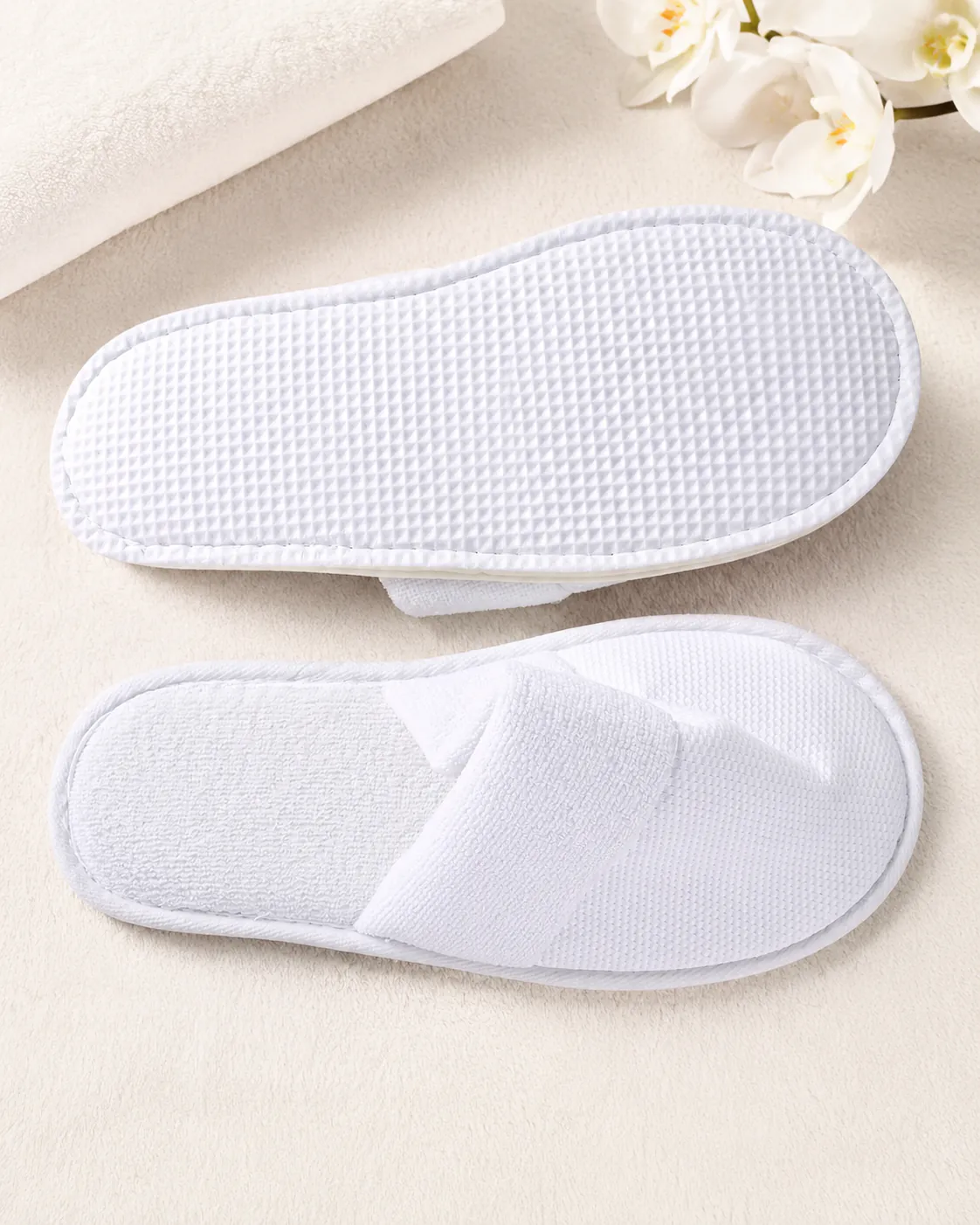 White hospitality slippers with terry and waffle textures